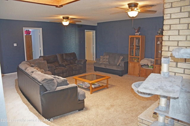 carpeted living room with ceiling fan and a textured ceiling