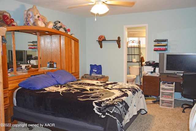 carpeted bedroom featuring ceiling fan and ensuite bathroom