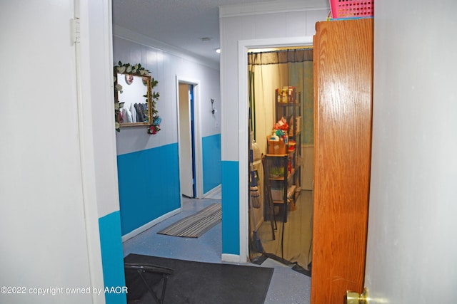 hall with baseboards and crown molding