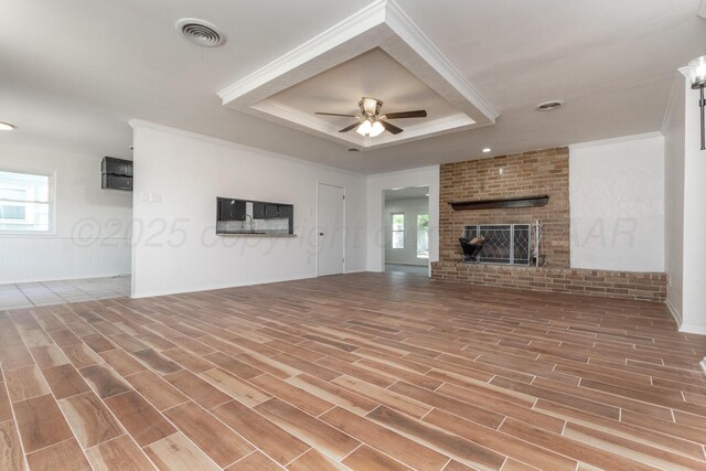 4808 SW 57th Ave, Amarillo, TX 79109 - unfurnished living room with a raised ceiling, ceiling fan, plenty of natural light, wood finished floors, and crown molding