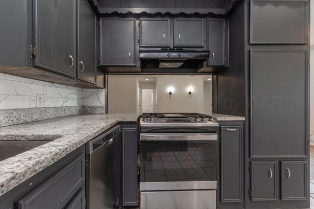 4808 SW 57th Ave, Amarillo, TX 79109 - kitchen with appliances with stainless steel finishes, under cabinet range hood, decorative backsplash, light stone countertops, and gray cabinets