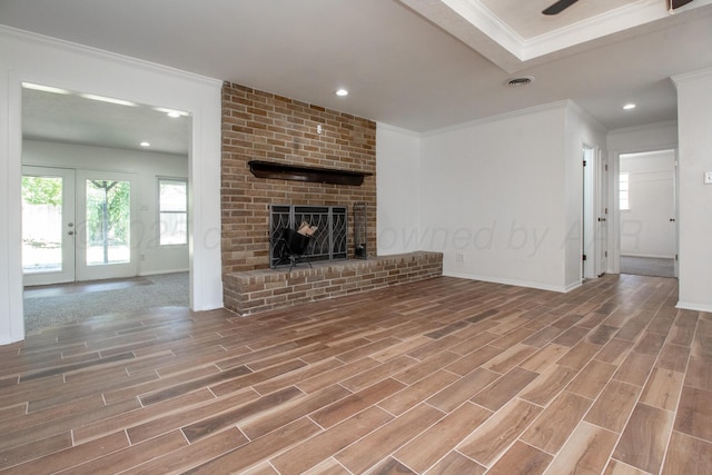 4808 SW 57th Ave, Amarillo, TX 79109 - unfurnished living room with crown molding, wood finished floors, plenty of natural light, a fireplace, and recessed lighting