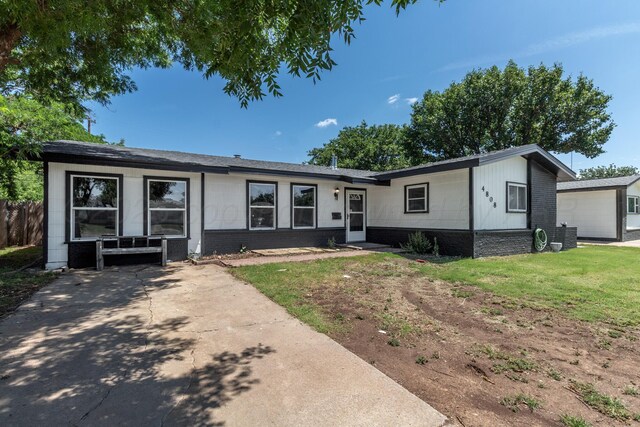 4808 SW 57th Ave, Amarillo, TX 79109 - ranch-style house with a front yard and brick siding