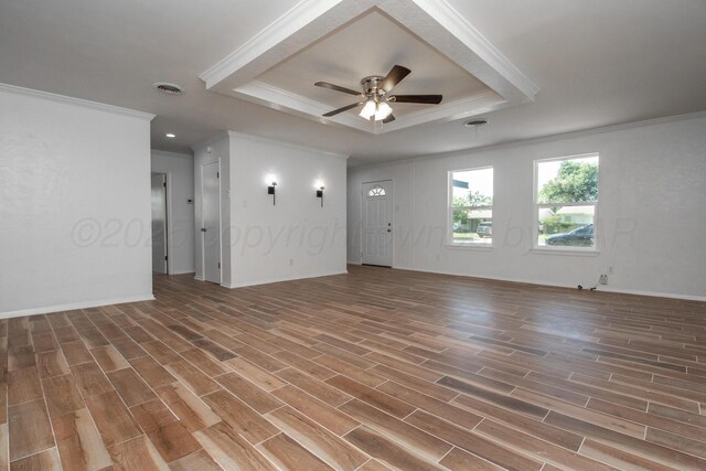 4808 SW 57th Ave, Amarillo, TX 79109 - unfurnished living room featuring ornamental molding, a tray ceiling, wood finished floors, and a ceiling fan