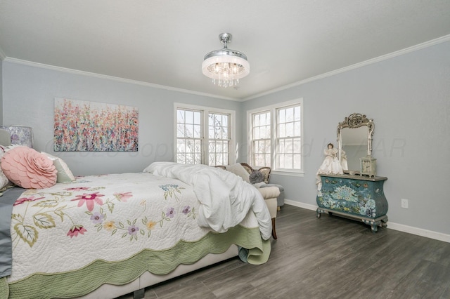 bedroom featuring crown molding, baseboards, and wood finished floors