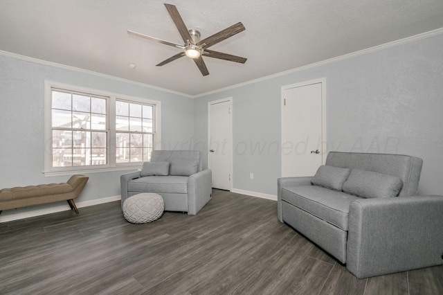 sitting room featuring baseboards, ornamental molding, ceiling fan, and dark wood-style flooring