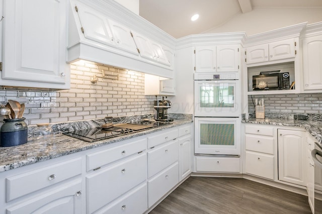 kitchen with dark wood-style flooring, vaulted ceiling with beams, custom exhaust hood, black appliances, and white cabinetry