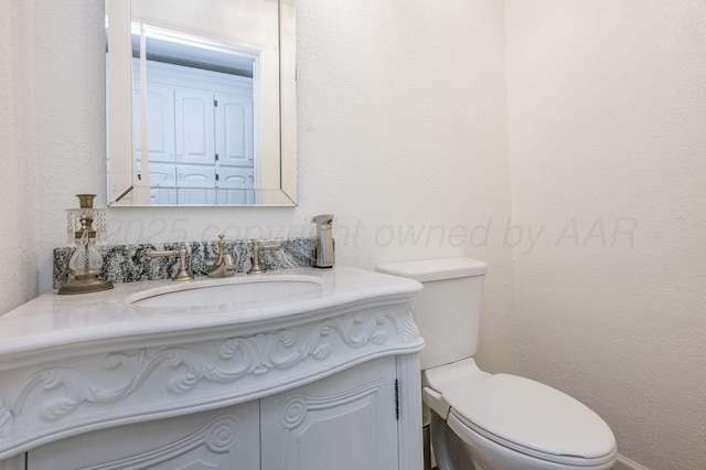 bathroom featuring toilet and vanity