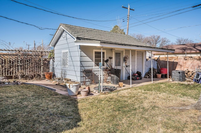 view of outbuilding featuring fence