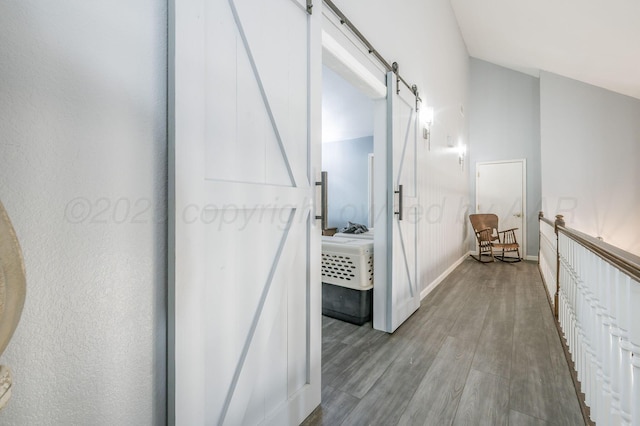 bathroom with baseboards, vaulted ceiling, and wood finished floors