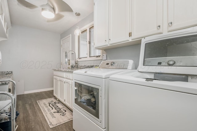 laundry room with ceiling fan, dark wood-type flooring, baseboards, cabinet space, and washing machine and clothes dryer