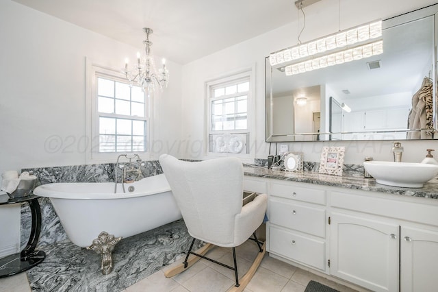 bathroom with vanity, a soaking tub, tile patterned flooring, and visible vents