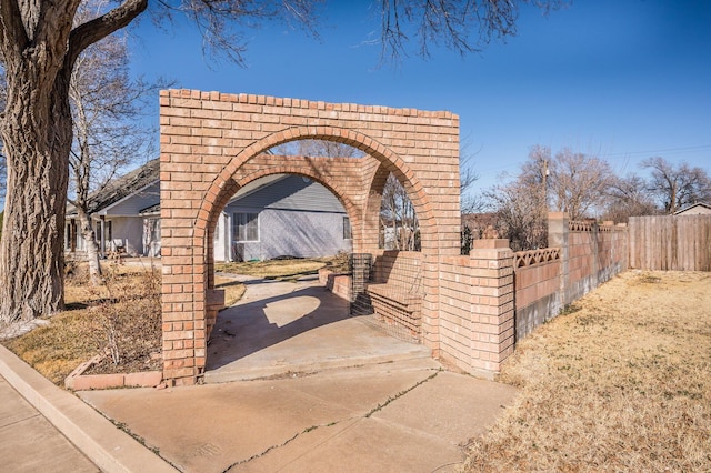 exterior space with fence and brick siding