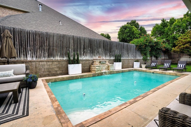 27 Carnoustie Ln, Amarillo, TX 79124 - pool at dusk featuring a fenced backyard, a patio area, and an outdoor living space