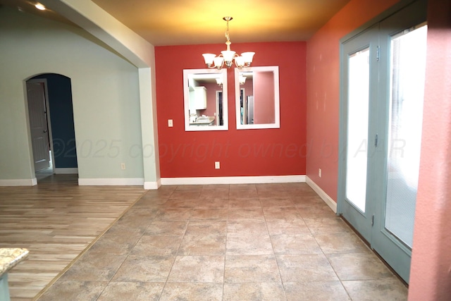 9807 Will Ave, Amarillo, TX 79119 - unfurnished dining area with arched walkways and a chandelier