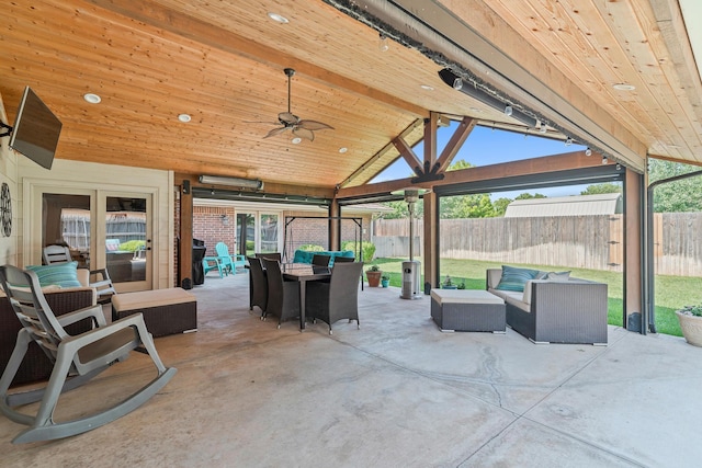 3523 Rutson Dr, Amarillo, TX 79109 - fenced backyard with an outdoor hangout area, outdoor dining area, a patio, and ceiling fan