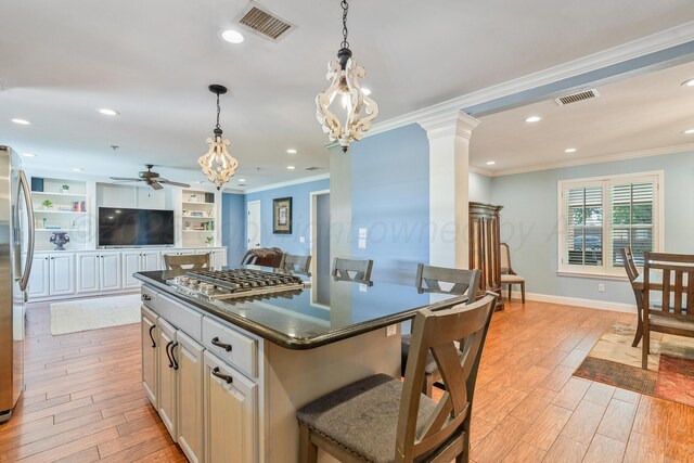 3523 Rutson Dr, Amarillo, TX 79109 - kitchen featuring appliances with stainless steel finishes, ceiling fan, ornamental molding, light wood finished floors, and dark countertops