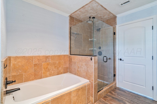3523 Rutson Dr, Amarillo, TX 79109 - bathroom featuring crown molding, a bath, a shower stall, and wood finished floors