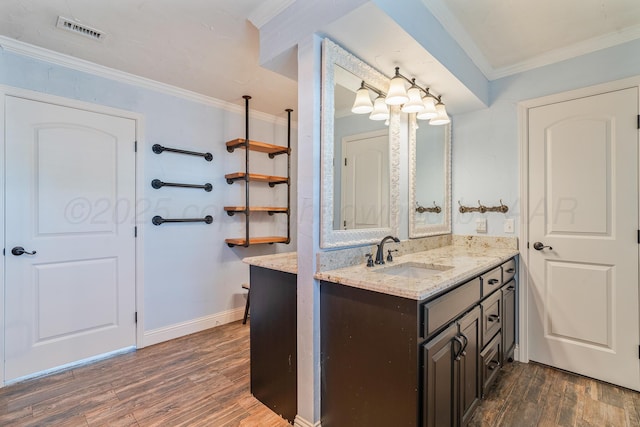 3523 Rutson Dr, Amarillo, TX 79109 - bathroom with wood finished floors, vanity, ornamental molding, and baseboards