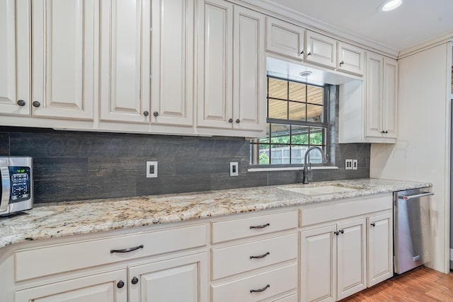 3523 Rutson Dr, Amarillo, TX 79109 - kitchen with a sink, stainless steel appliances, tasteful backsplash, light wood finished floors, and light stone countertops