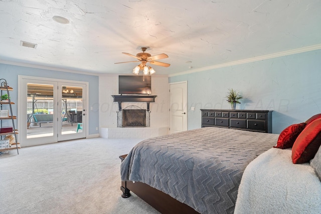 3523 Rutson Dr, Amarillo, TX 79109 - carpeted bedroom featuring access to outside, ornamental molding, a fireplace with raised hearth, and ceiling fan