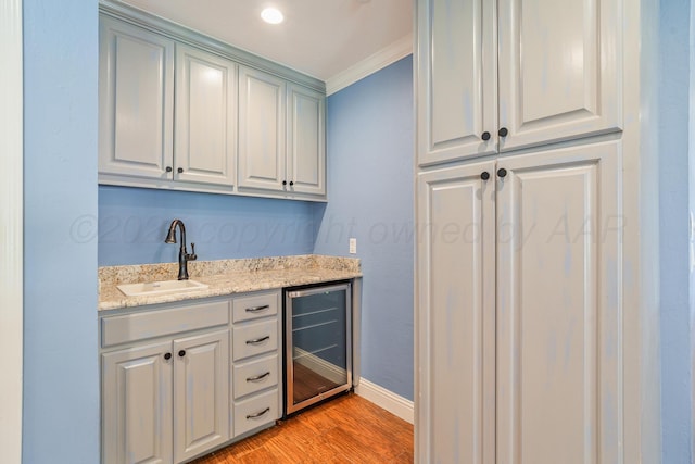 3523 Rutson Dr, Amarillo, TX 79109 - bar with beverage cooler, a sink, light wood-style floors, crown molding, and baseboards
