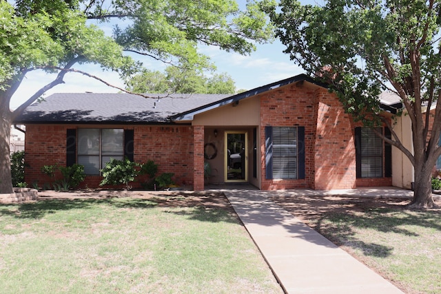 3014 Edgemere Dr, Plainview, TX 79072 - view of front facade with brick siding, a front lawn, and roof with shingles