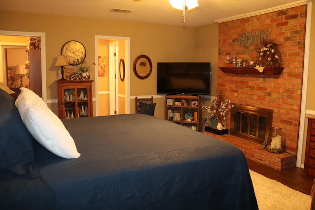 3014 Edgemere Dr, Plainview, TX 79072 - bedroom featuring wood finished floors and a fireplace