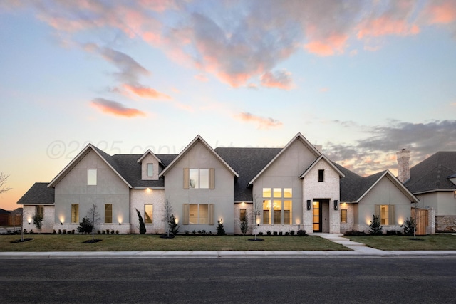 modern inspired farmhouse featuring a shingled roof and stucco siding