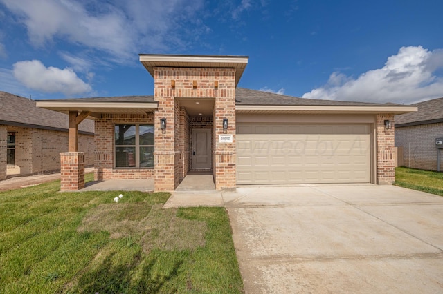 10502 Ruse St, Amarillo, TX 79118 - view of front of property with brick siding, driveway, a garage, and a front lawn