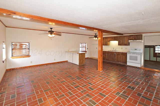 kitchen featuring sink, beam ceiling, a textured ceiling, white electric stove, and kitchen peninsula