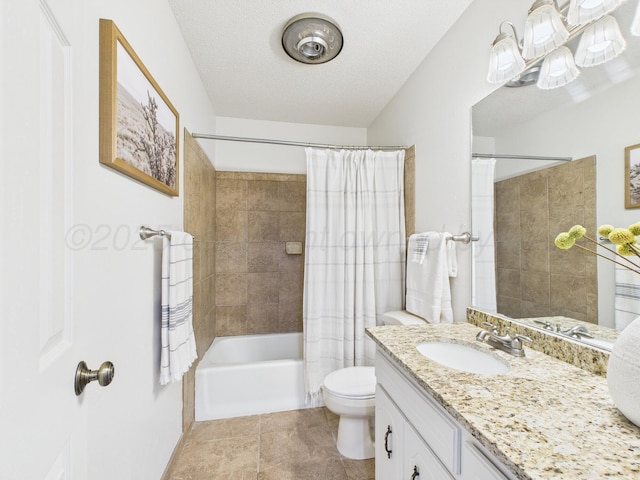 bathroom featuring vanity, tile patterned floors, shower / tub combo with curtain, a textured ceiling, and toilet