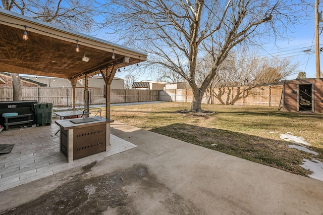 view of patio / terrace featuring a storage shed and a fire pit