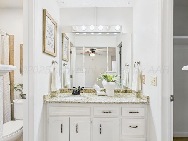 full bath featuring vanity, a ceiling fan, and toilet
