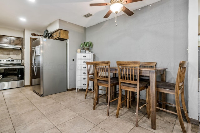 dining room featuring ceiling fan and light tile patterned flooring