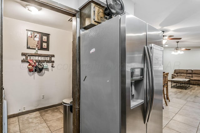 kitchen featuring stainless steel fridge with ice dispenser and light tile patterned floors