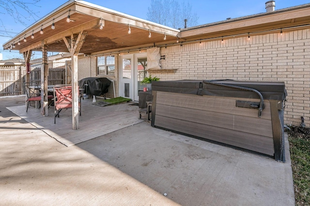 view of patio / terrace with a hot tub and area for grilling