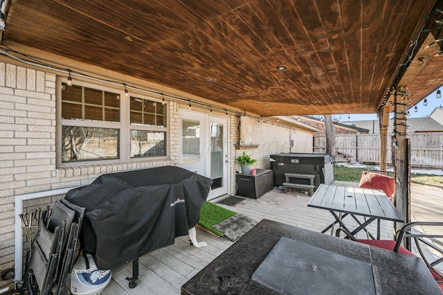 view of patio / terrace featuring a hot tub and area for grilling