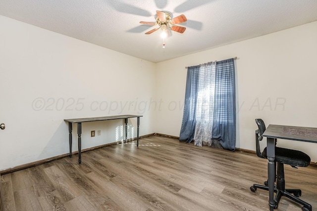 office area with a textured ceiling, ceiling fan, and wood-type flooring