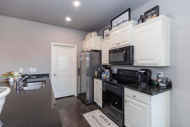 kitchen with black appliances, a sink, white cabinetry, recessed lighting, and dark stone counters