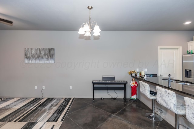 dining area with a chandelier, recessed lighting, and baseboards