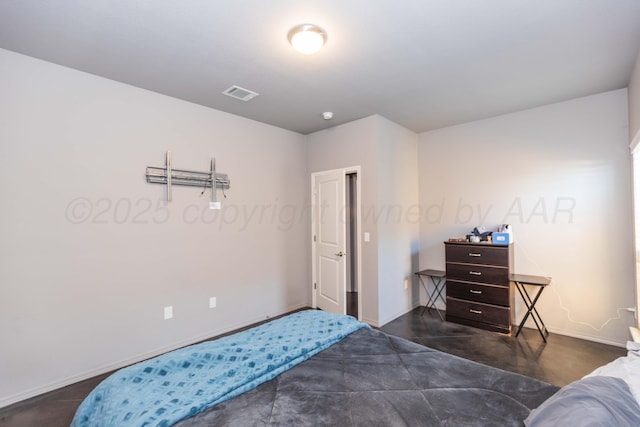 bedroom featuring baseboards and concrete floors