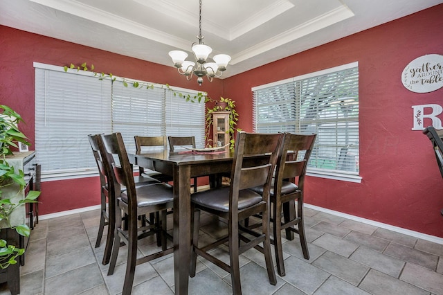 tiled dining space with a tray ceiling, a notable chandelier, baseboards, and ornamental molding