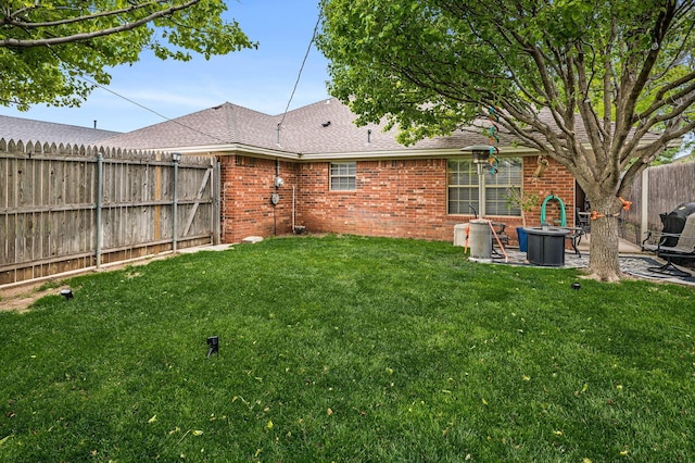 view of yard with a fenced backyard and a patio