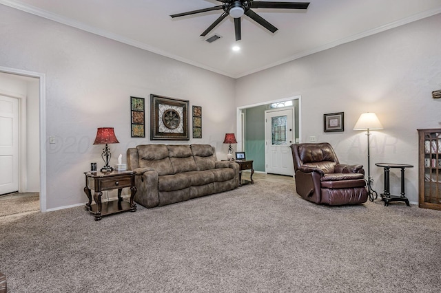 carpeted living room featuring visible vents, a ceiling fan, baseboards, and ornamental molding