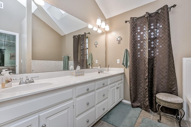 full bathroom with vaulted ceiling with skylight, a sink, visible vents, and double vanity