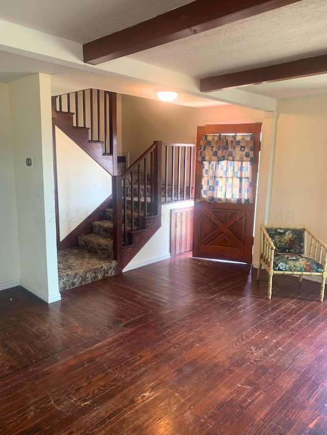 foyer entrance featuring hardwood / wood-style flooring and beamed ceiling