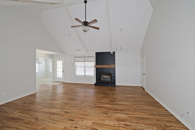 unfurnished living room with high vaulted ceiling, hardwood / wood-style flooring, ceiling fan, and a brick fireplace