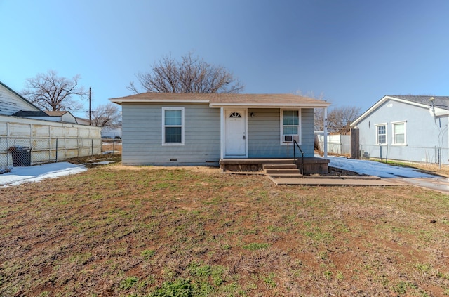 exterior space with a porch, crawl space, fence, and a lawn