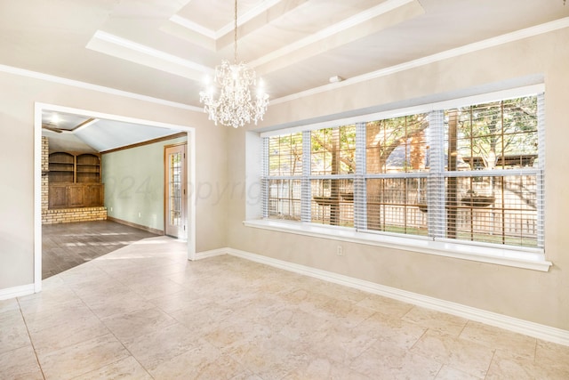 spare room featuring a wealth of natural light, a raised ceiling, and ornamental molding